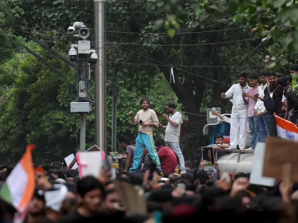 Mobile AI-powered police surveillance vehicle monitoring student protesters in New Delhi.
