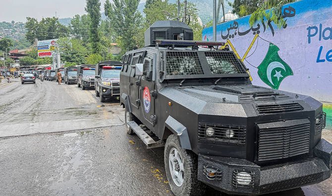 Voters cast ballots at a polling station in Mirpur during the first phase of Azad Kashmir general elections under heightened security.