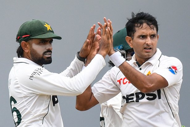 Babar Azam and Mohammad Abbas celebrate during a Pakistan Test match after improving in the ICC Test rankings.