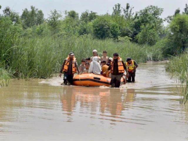 Border Military Police personnel rescuing stranded tourists during flash floods in Dera Ghazi Khan after heavy monsoon rainfall.