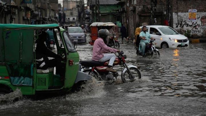 Rescue workers inspect flood-affected homes after heavy monsoon rains in Pakistan.