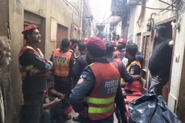 Rescue workers clearing debris after a house roof collapsed in Lahore's Harbanspura area.