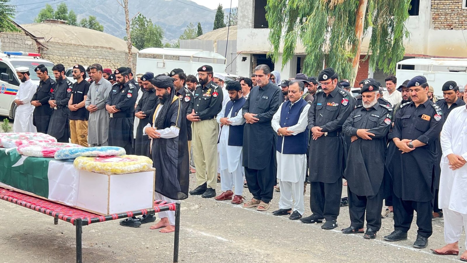 Police officers present a guard of honor during the state funeral of martyred Constable Muhammad Mehran in Wana.