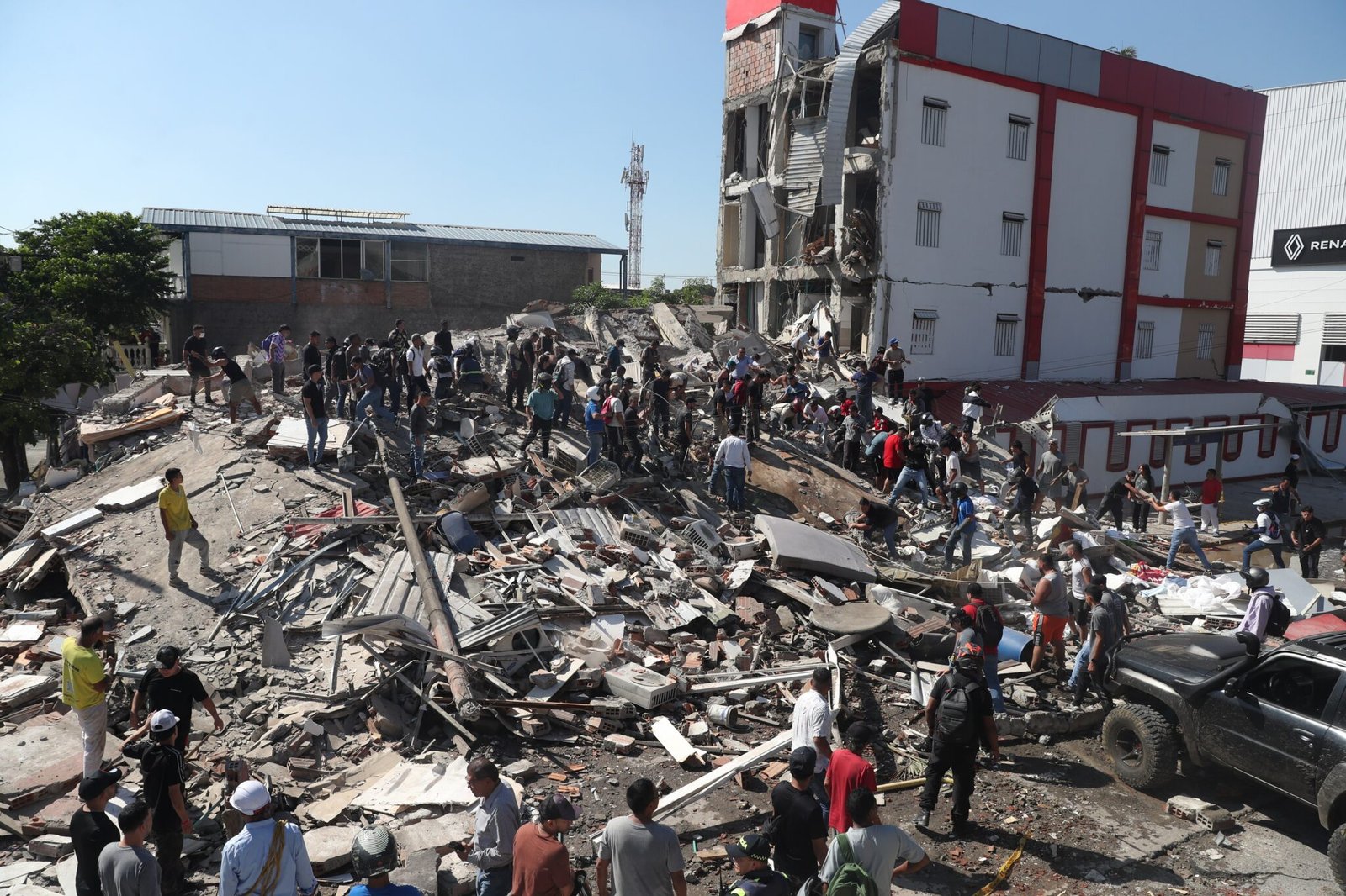 Rescue workers search through rubble after a powerful 7.4 magnitude earthquake in Colombia