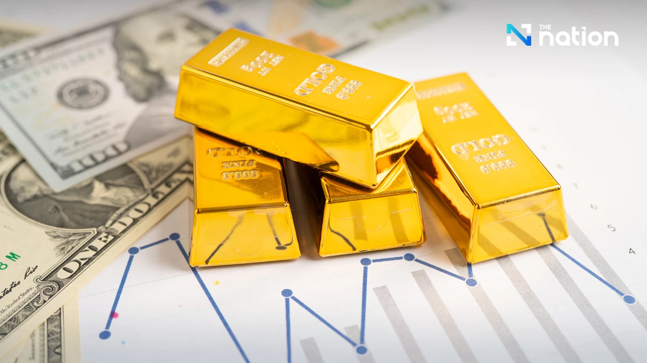 Gold bars and financial market charts as gold prices rise on weaker US dollar and Federal Reserve rate expectations