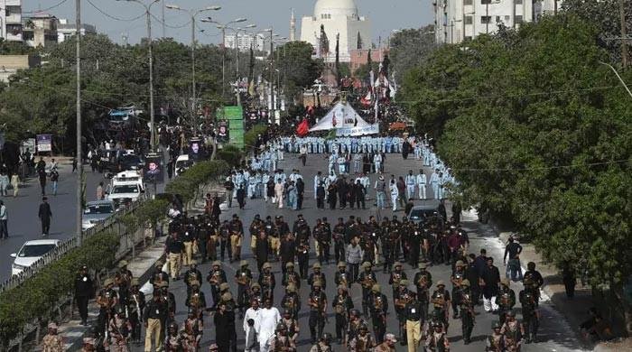 Traffic police personnel managing vehicles near M.A. Jinnah Road ahead of the Chehlum procession in Karachi.