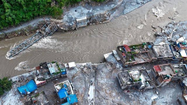 Rescue teams search through flood-damaged areas in Nepal after catastrophic flash floods