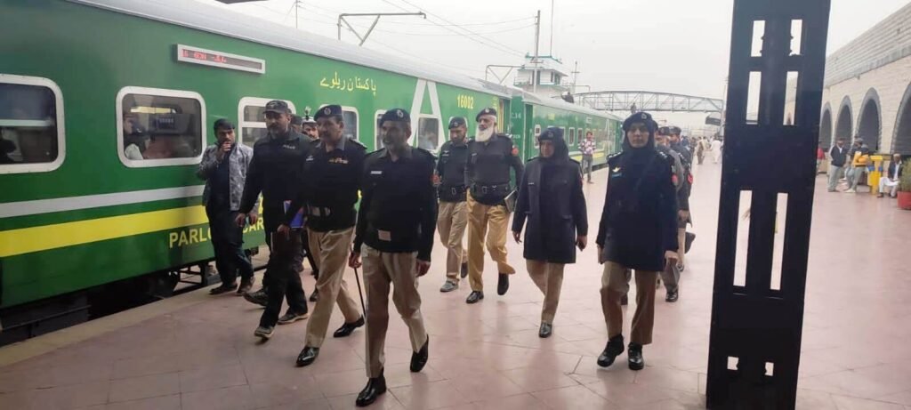 Pakistan Railways Police officials checking passenger tickets inside a train