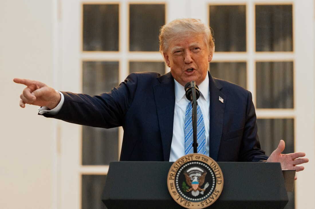 Donald Trump speaks to reporters in the White House as CNN, MS NOW and Politico face an announced access ban