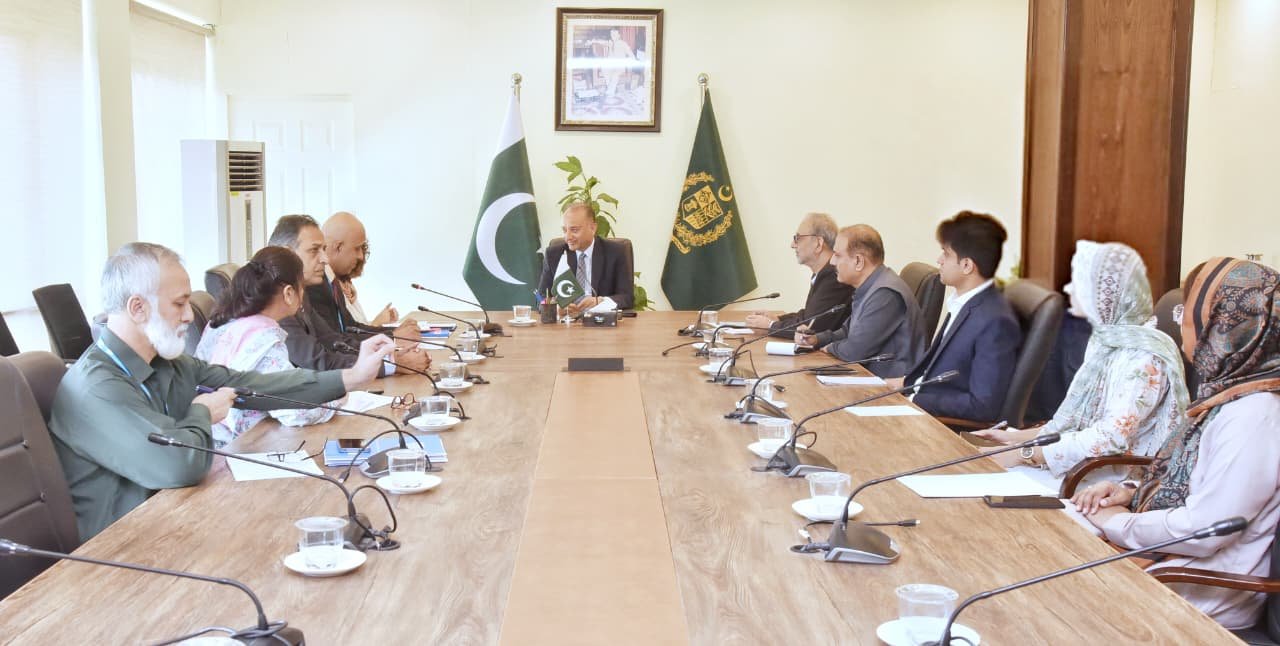Federal Minister Muscad Malik meeting a UN-Habitat officer to discuss climate resilience and urban development in Pakistan
