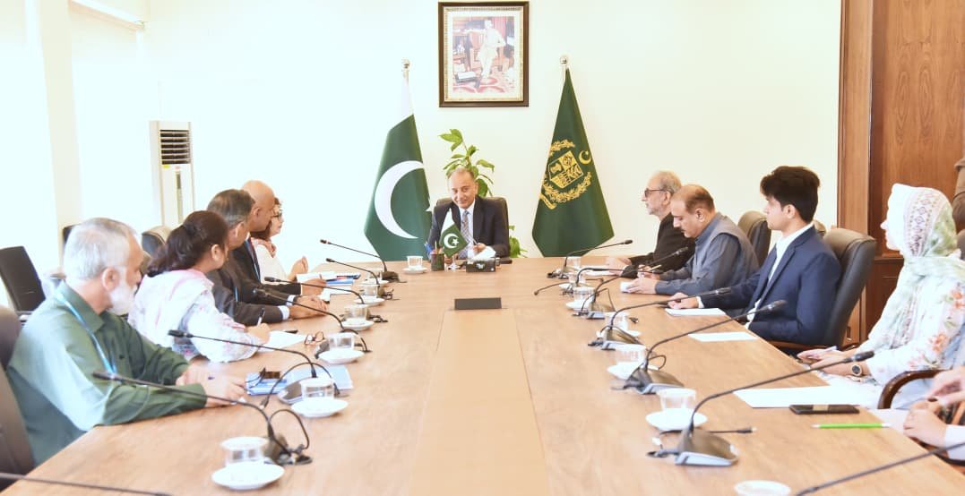 Federal Minister Muscad Malik meeting a UN-Habitat officer to discuss climate resilience and urban development in Pakistan