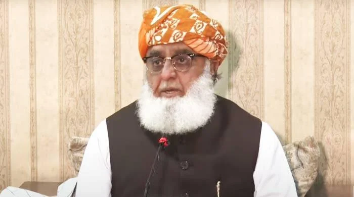 Maulana Fazlur Rehman speaks to reporters alongside opposition leaders in Islamabad
