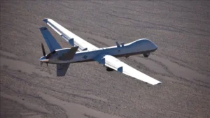 Illustration of a US MQ-9 Reaper drone flying over the Strait of Hormuz amid reported Iranian claims of a drone shootdown.