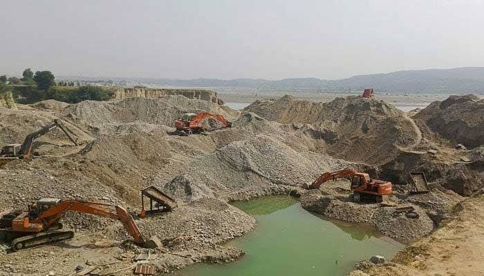 KP Gold Mining Contracts Worth Rs4.93 Billion Face NAB Scrutiny Over Alleged Irregularities Gold mining excavators operating along a riverbank in Khyber Pakhtunkhwa, illustrating scrutiny of gold mining contracts and alleged regulatory irregularities.